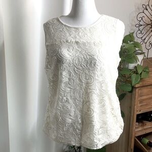 Very cute white  sleeveless top. Size large.